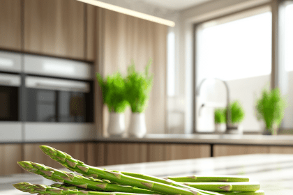Fresh asparagus stalks on a marble countertop in a modern kitchen, with natural light highlighting their vibrant green color.