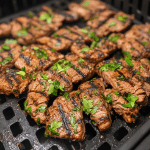 Grilled meat with fresh parsley cooked in an air fryer, perfectly golden and juicy.